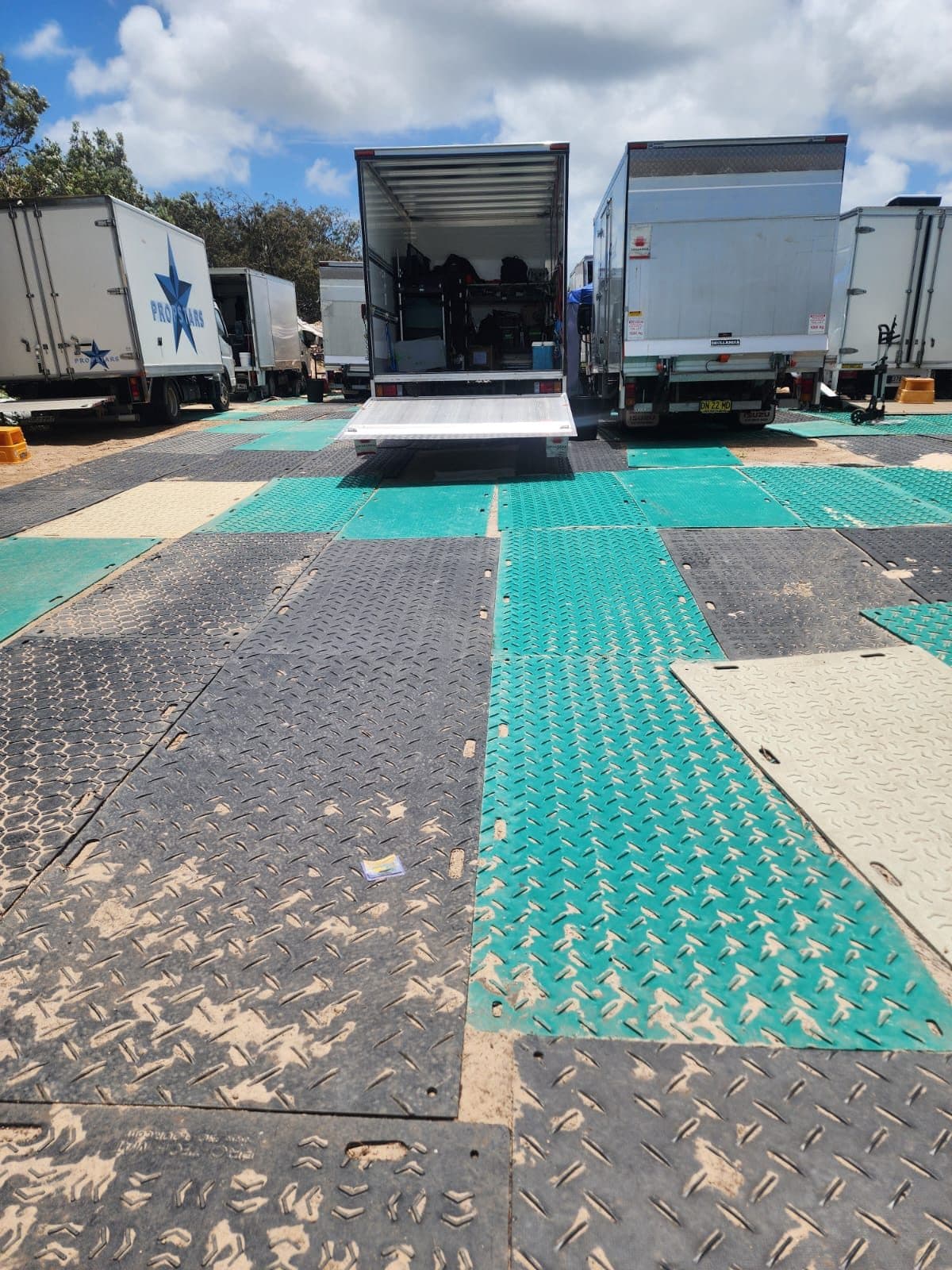Interlocking track mats laid out for vehicle access