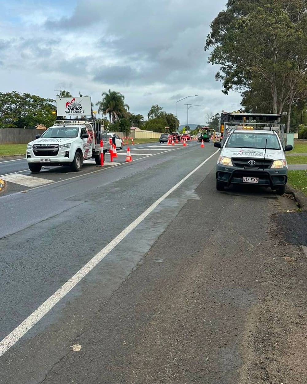 Two Safe Knight utes protecting a lane closure with bollards and cones